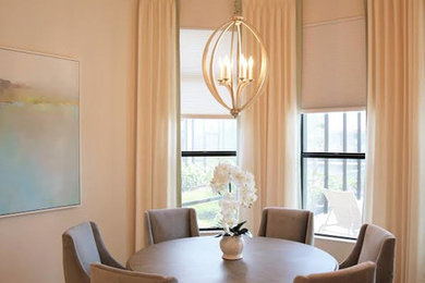 Enclosed dining room - mid-sized transitional travertine floor and brown floor enclosed dining room idea in Miami with beige walls and no fireplace