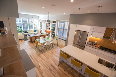 Photo of a mid-sized modern open plan dining in Other with grey walls, light hardwood floors, no fireplace and brown floor.
