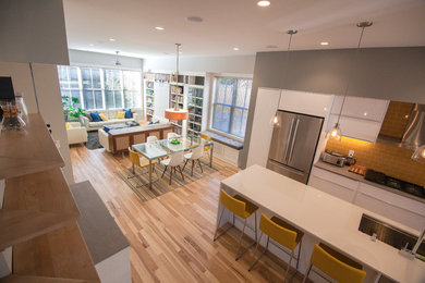 Great room - mid-sized modern light wood floor and brown floor great room idea in Other with gray walls and no fireplace