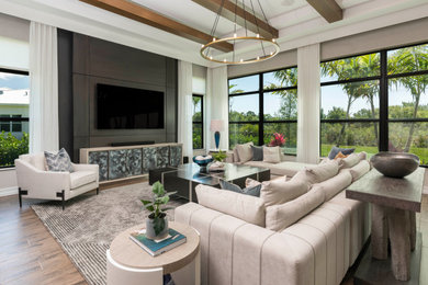 Open concept exposed beam and wall paneling family room photo in Other