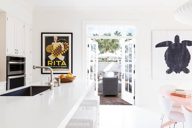 Photo of a beach style kitchen in Miami with white splashback.