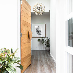 Design ideas for a scandinavian entryway in Melbourne with white walls, a single front door and a light wood front door.