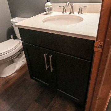 Powder Room with Onyx Vanity with Antique White Quartz Countertop