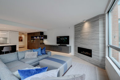 Living room - large modern open concept light wood floor and beige floor living room idea in Vancouver with white walls, a corner fireplace, a tile fireplace and a wall-mounted tv