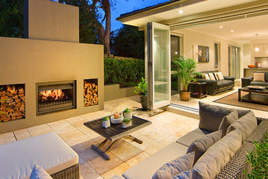 Patio - large transitional backyard tile patio idea in Tampa with a fire pit and no cover