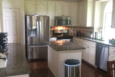 Kitchen pantry - mid-sized u-shaped kitchen pantry idea in Dallas with flat-panel cabinets, distressed cabinets and an island