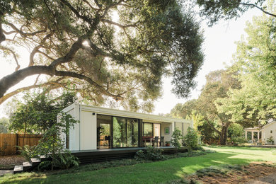 Example of a trendy white one-story flat roof design in San Francisco