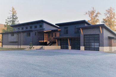 Inspiration for a modern gray two-story concrete fiberboard house exterior remodel in Seattle with a shed roof and a metal roof