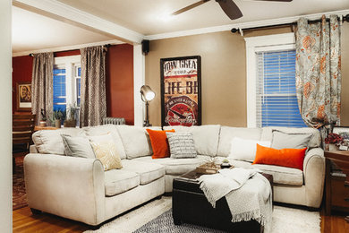 Example of a mid-sized classic open concept light wood floor family room design in Boston with brown walls