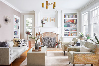 Example of a mid-sized transitional enclosed and formal medium tone wood floor and brown floor living room design in New York with a standard fireplace, a stone fireplace, no tv and beige walls