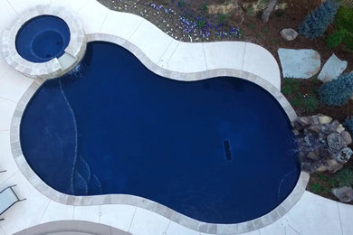 Minimalist courtyard custom-shaped pool house photo in Oklahoma City