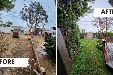 This is an example of a modern full sun backyard stone fence formal garden in Los Angeles with a fireplace and decking for spring.