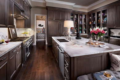 Large transitional u-shaped dark wood floor and brown floor eat-in kitchen photo in Salt Lake City with a double-bowl sink, dark wood cabinets, white backsplash, stainless steel appliances, marble countertops, stone slab backsplash, an island and recessed-panel cabinets