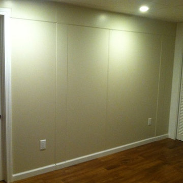 Trimming seams on a plain wall panel.