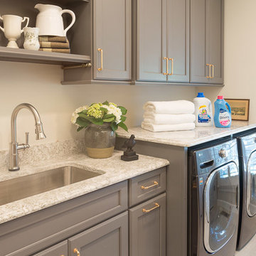 Gray Laundry Room with Brass Hardware