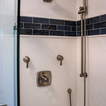 Primary Bathroom with Blue-Gray Vanity and Deep Blue Tiled Feature Wall