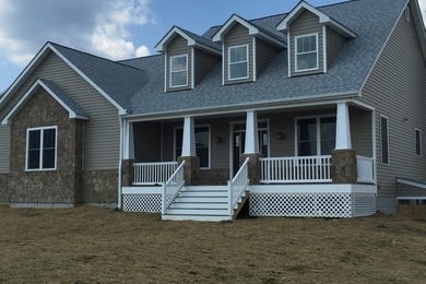 Inspiration for a large craftsman beige two-story wood gable roof remodel in DC Metro