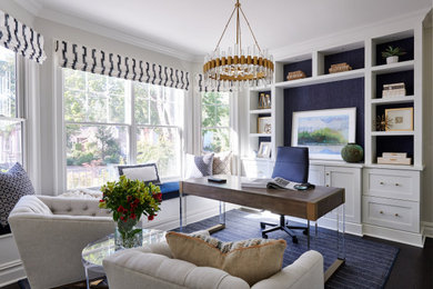 Example of a transitional freestanding desk dark wood floor study room design in New York