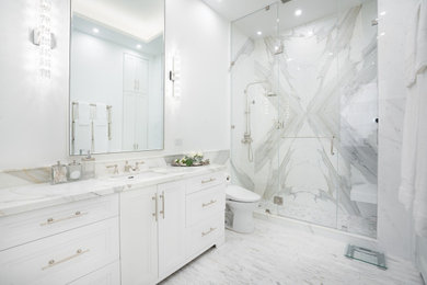 Inspiration for a transitional master bathroom in New York with recessed-panel cabinets, white cabinets, an alcove shower, an undermount sink, marble benchtops, grey floor, a hinged shower door, a single vanity and a built-in vanity.
