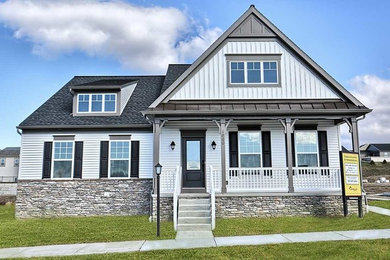Example of a mid-sized classic white two-story vinyl exterior home design in Other with a mixed material roof