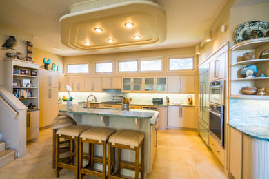 Inspiration for a large mid-century modern u-shaped ceramic tile and beige floor open concept kitchen remodel in Denver with a double-bowl sink, flat-panel cabinets, light wood cabinets, granite countertops, green backsplash, matchstick tile backsplash, stainless steel appliances and an island