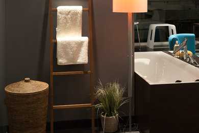 Design ideas for a large contemporary master bathroom in Frankfurt with flat-panel cabinets, white cabinets, a drop-in tub, a curbless shower, a bidet, white tile, terra-cotta tile, grey walls, light hardwood floors, a vessel sink, wood benchtops, brown floor and a sliding shower screen.