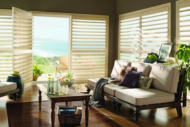 Example of a mid-sized island style enclosed bamboo floor and brown floor living room design in Toronto with gray walls and no fireplace