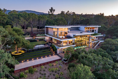 Inspiration for a huge contemporary gray three-story concrete exterior home remodel in San Francisco with a tile roof