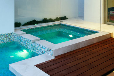 Modern custom-shaped pool in Perth with a water feature.