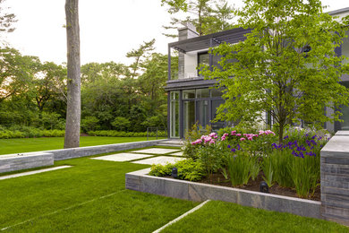 Inspiration for a contemporary backyard stone landscaping in Boston.