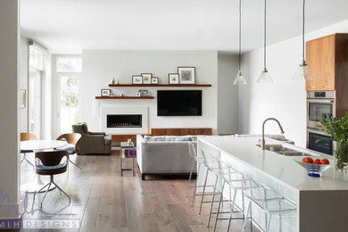 Inspiration for a large modern l-shaped medium tone wood floor eat-in kitchen remodel in Little Rock with an undermount sink, flat-panel cabinets, medium tone wood cabinets, quartz countertops, gray backsplash, marble backsplash, stainless steel appliances and an island