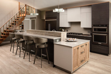 Inspiration for a contemporary l-shaped medium tone wood floor and brown floor eat-in kitchen remodel in Other with quartz countertops, black appliances, an island, flat-panel cabinets, brown cabinets, gray backsplash and gray countertops