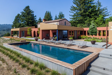 Large contemporary backyard rectangular lap pool in San Francisco with a pool house and tile.