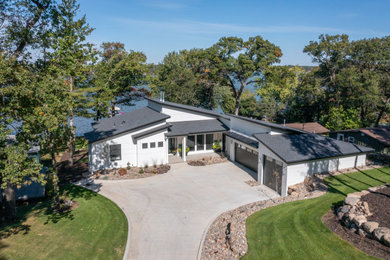 Inspiration for a large timeless white house exterior remodel in Minneapolis with a shingle roof and a gray roof