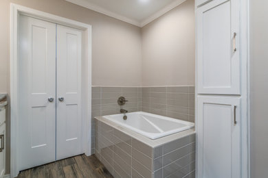Bathroom - contemporary master gray tile and ceramic tile ceramic tile, gray floor and double-sink bathroom idea in Other with recessed-panel cabinets, white cabinets, beige walls, an undermount sink, quartzite countertops and a built-in vanity