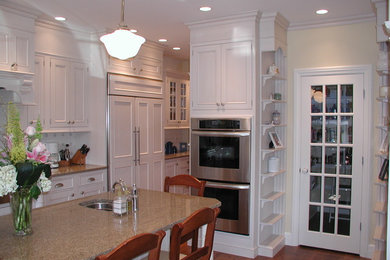 Eat-in kitchen - large transitional l-shaped medium tone wood floor and brown floor eat-in kitchen idea in New York with a drop-in sink, beaded inset cabinets, white cabinets, laminate countertops, white backsplash, ceramic backsplash, stainless steel appliances, an island and beige countertops