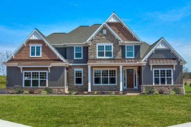 Inspiration for a huge craftsman gray two-story mixed siding exterior home remodel in Other with a mixed material roof