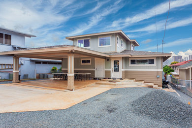 Inspiration for a large tropical blue two-story wood flat roof remodel in Hawaii