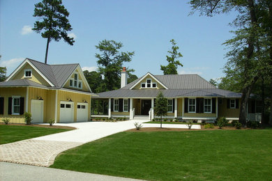Large transitional yellow one-story gable roof photo in Atlanta