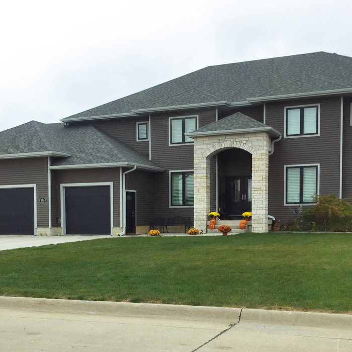 Transitional gray two-story vinyl exterior home photo in Cedar Rapids with a hip roof