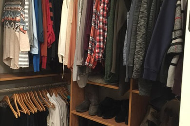 Walk-in closet - mid-sized traditional gender-neutral light wood floor walk-in closet idea in Birmingham with flat-panel cabinets and light wood cabinets