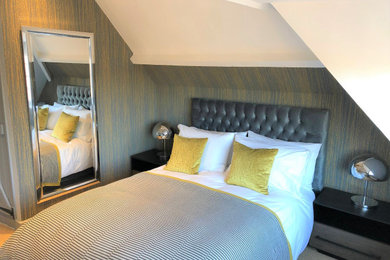 Eclectic guest bedroom with multi-coloured walls, carpet and beige floors.