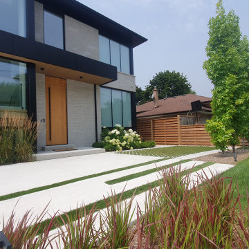 Artificial turf accent in concrete walkway