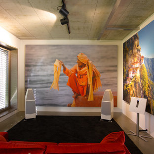 Home theater - small contemporary enclosed concrete floor and gray floor home theater idea in Munich with white walls and a projector screen