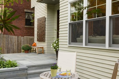 Traditional patio in Boston with a container garden, concrete pavers and no cover.