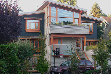 Large contemporary gray three-story mixed siding house exterior idea in Vancouver with a shed roof