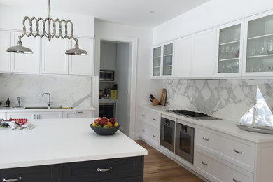 Design ideas for a large modern l-shaped open plan kitchen in Sydney with a double-bowl sink, shaker cabinets, white cabinets, quartz benchtops, white splashback, marble splashback, stainless steel appliances, light hardwood floors and with island.