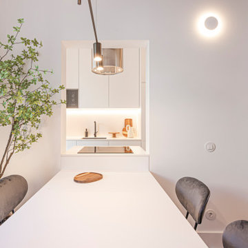 Dining Table Framed by Kitchen Opening and Pendant Light