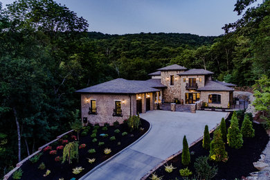 Large mountain style multicolored two-story mixed siding house exterior photo in Other with a hip roof and a shingle roof
