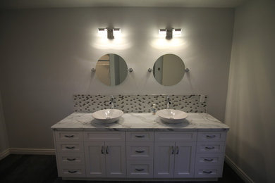 Minimalist mosaic tile vinyl floor bathroom photo in Other with shaker cabinets, white cabinets, a vessel sink and laminate countertops